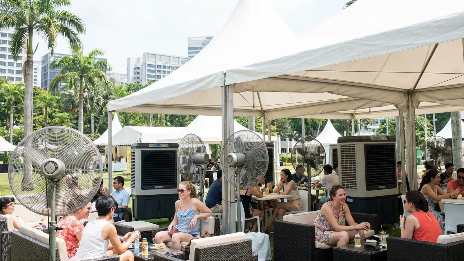 Large industrial fans and evaporative air coolers keeping guests cool at an outdoor event in Singapore