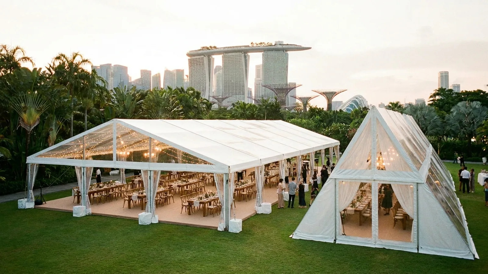 A large white clearspan marquee tent set up for an outdoor event in Singapore, with an A-frame tent alongside it