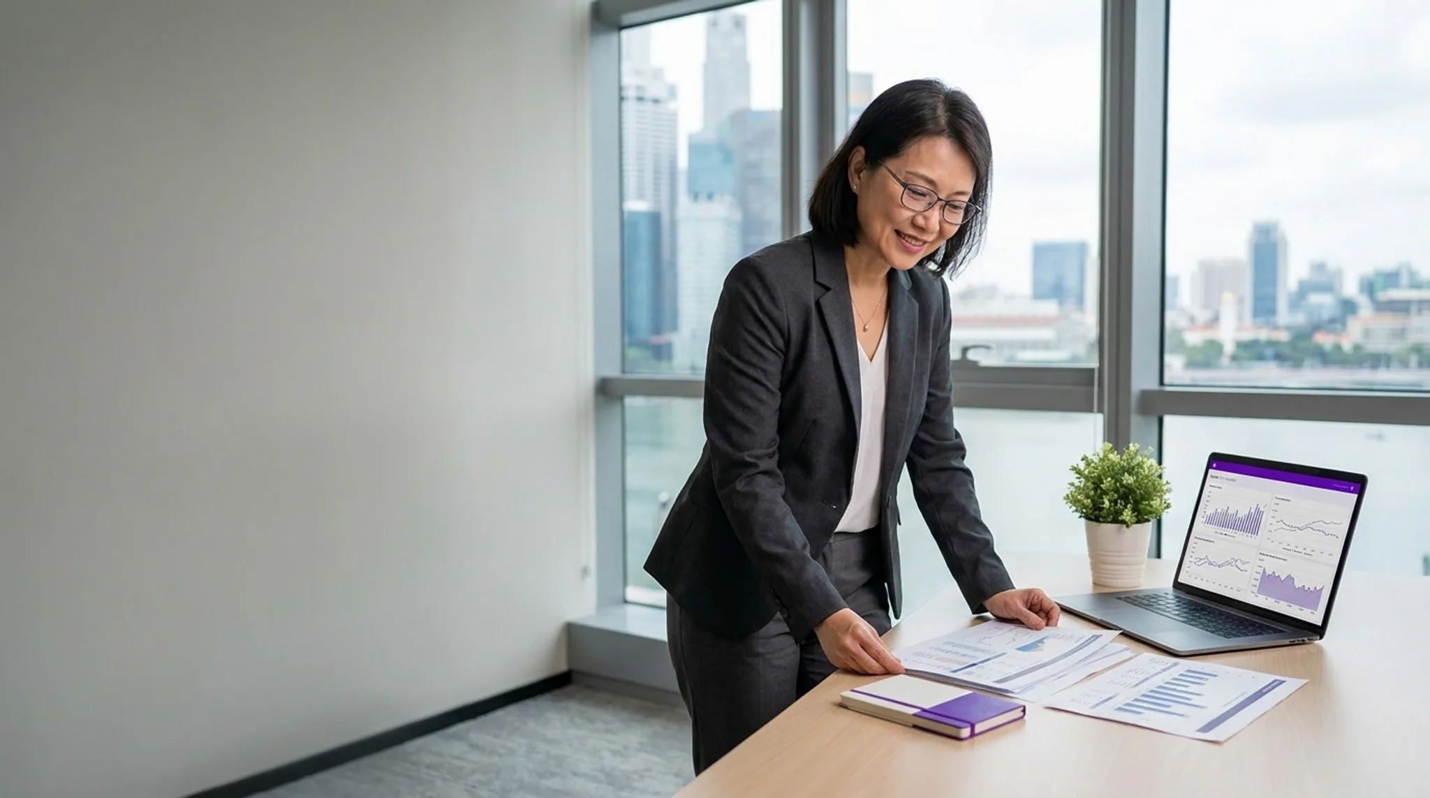 Accountant reviewing financial statements on a laptop in a Singapore office, with accounting services search results on screen