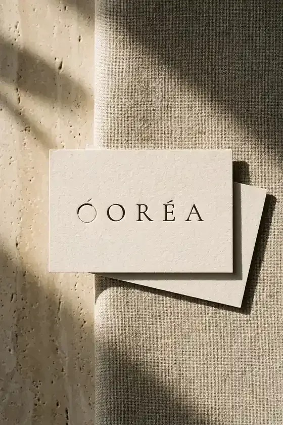 Oréa business card, letterpressed on uncoated board, resting on travertine in raking daylight