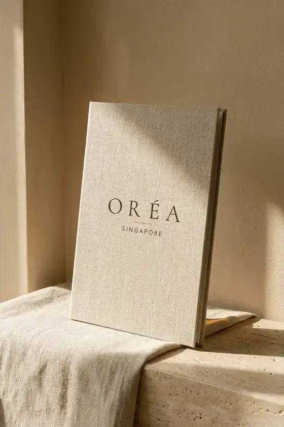 Oréa treatment menu, A5, standing against a warm plaster wall