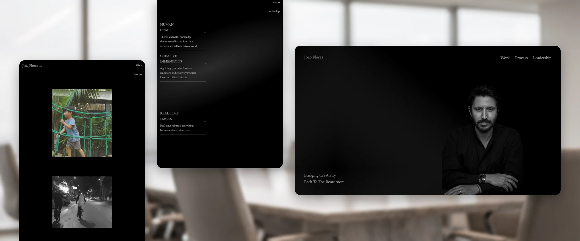 Three João Flores pages over an empty boardroom with a glass wall onto a hazy city, softly out of focus: Work, the run of work pieces in black frames; Process, three principles, "Human Craft", "Creative Dimensions" and "Real-Time Hacks", on black; and the homepage, "Bringing Creativity Back To The Boardroom"